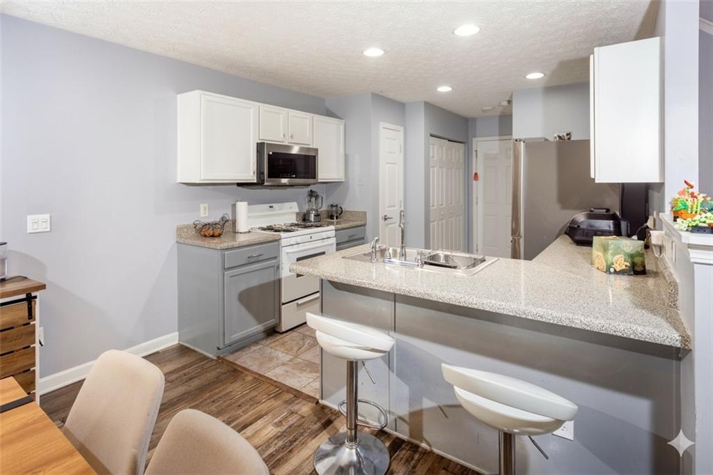 269 Silver Ridge Drive Dallas, GA 30157 - Photo 12 of 33 a kitchen with a sink microwave and cabinets