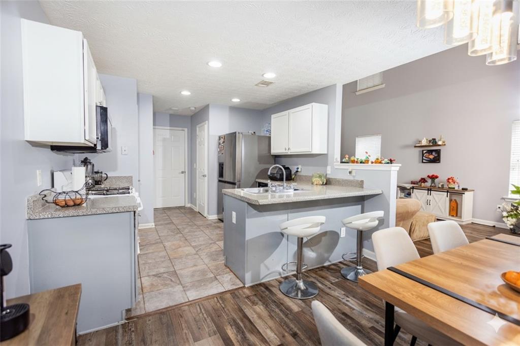 269 Silver Ridge Drive Dallas, GA 30157 - Photo 13 of 33 a kitchen with white cabinets sink and stove