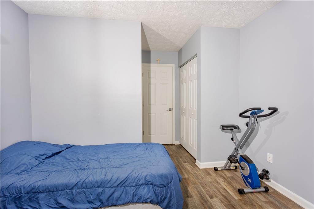 269 Silver Ridge Drive Dallas, GA 30157 - Photo 31 of 33 a bedroom with a bed and a wooden floor