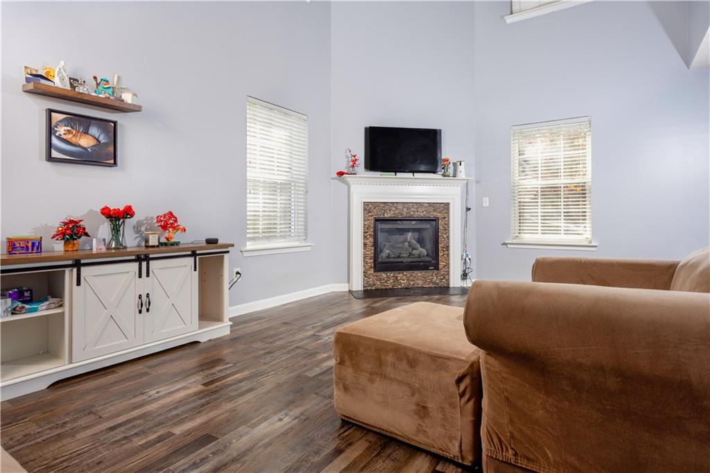 269 Silver Ridge Drive Dallas, GA 30157 - Photo 9 of 33 a living room with furniture a flat screen tv and a fireplace