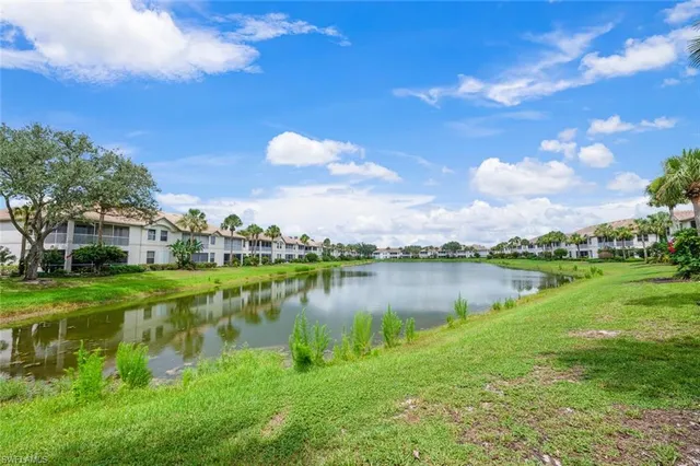 a view of a lake with a house in the background