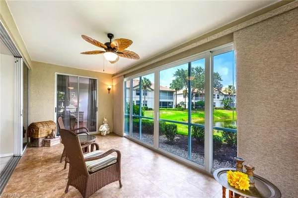 a living room with furniture and a floor to ceiling window