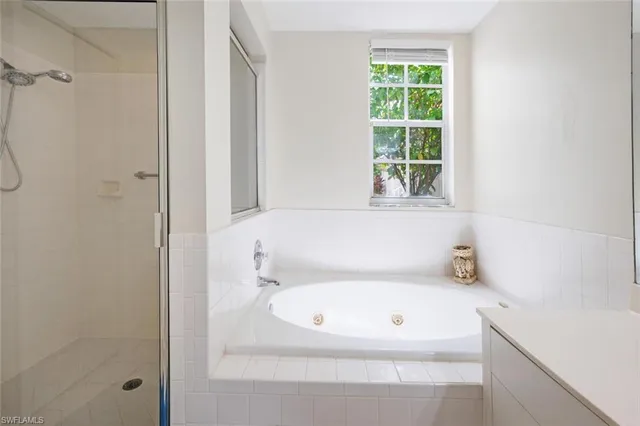 a bathroom with a bathtub and window