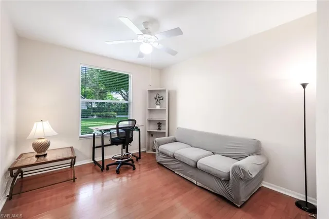 a living room with furniture and a lamp
