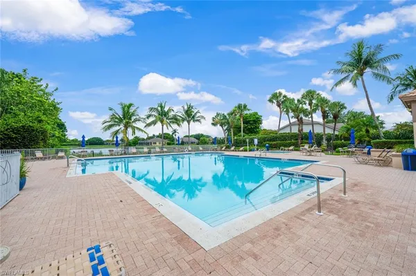 a view of swimming pool with a table and chairs