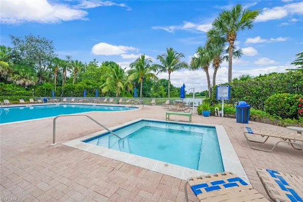 a view of swimming pool with outdoor seating and plants