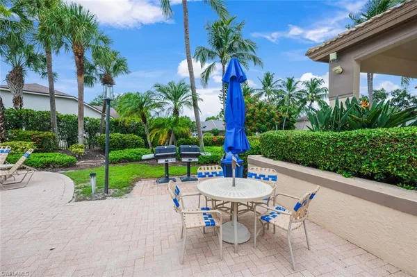 a view of an outdoor sitting area with chairs and table in patio