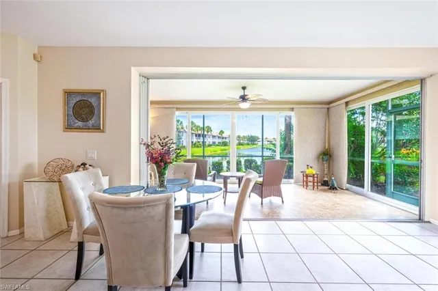 a dining room with furniture and large windows