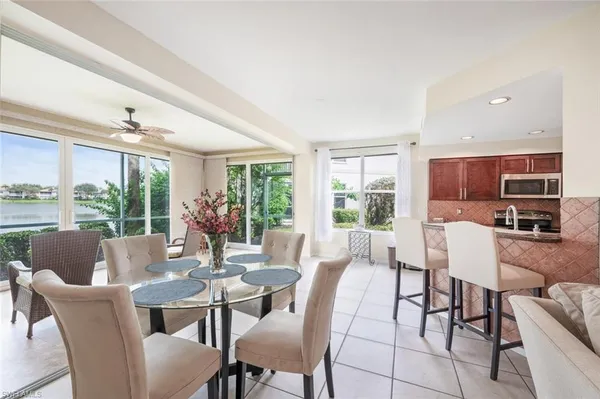 a view of a dining room with furniture large windows and wooden floor