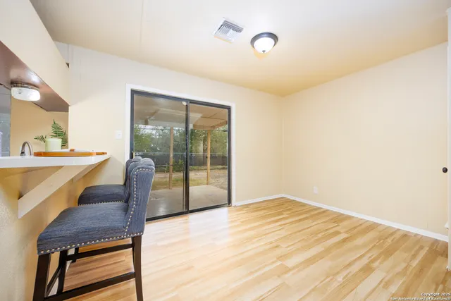 a view of a room with a balcony and wooden floor