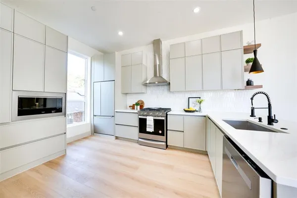a white painted room with a fireplace and a window