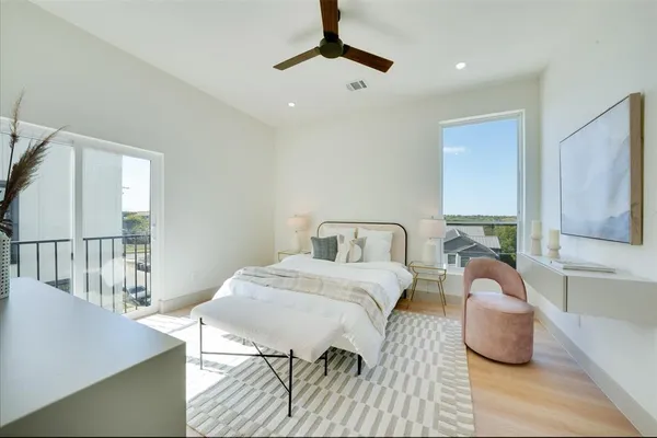 a bedroom with two beds and a large window
