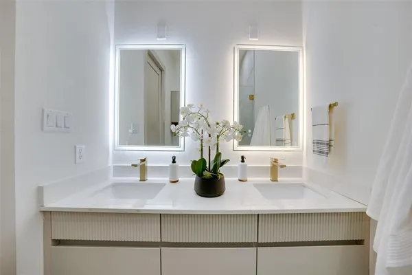 a bedroom with a bed and a mirror