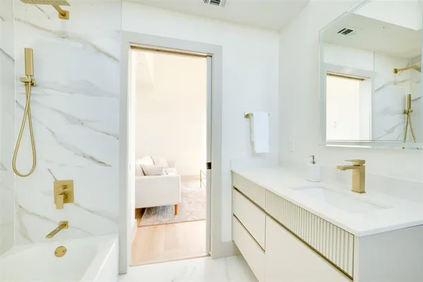 a bathroom with a bathtub and a shower