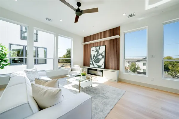 a living room with furniture large window and flat screen tv