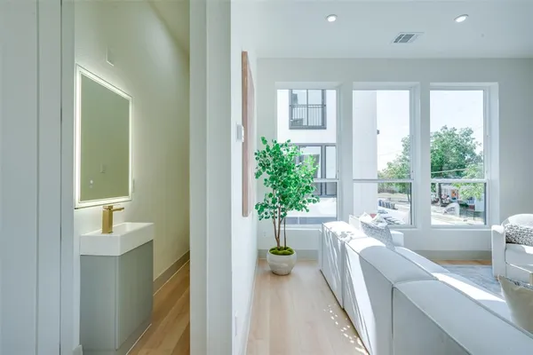 a large white kitchen with a large window