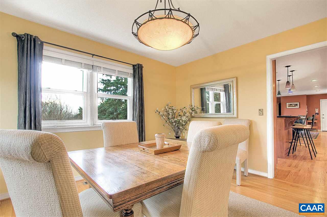 1532 Dairy Road Charlottesville, VA 22903 - Photo 13 of 42 Set in a sunny back corner of the home, with convenient access to the kitchen, the dining room is a refreshing space. A large double window looks out at the views beyond the back yard.