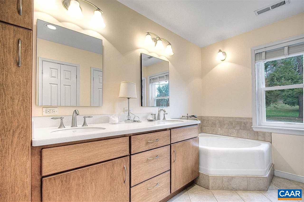 1532 Dairy Road Charlottesville, VA 22903 - Photo 23 of 42 The master bath is a harmonious blend of clean, simple lines and elegant details. An expansive double vanity with linen cupboard anchors the room that has separate shower & tub and private alcove for the toilet.
