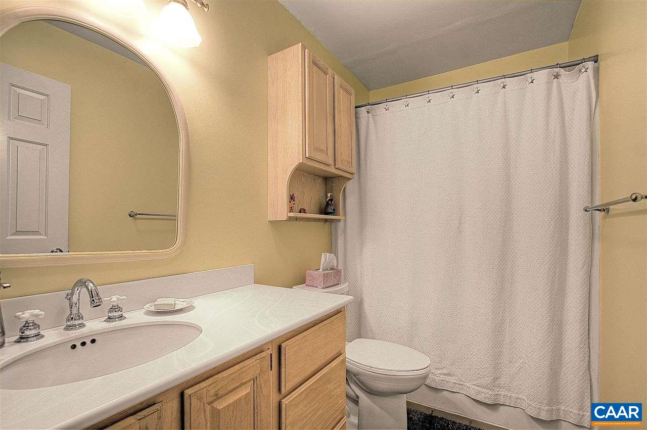 1532 Dairy Road Charlottesville, VA 22903 - Photo 28 of 42 The hall bath accommodates the second and third bedrooms. A lightly glazed oak vanity has a drawer stack in addition to cupboard which, along with a cabinet over the toilet, provides ample storage for toiletries.