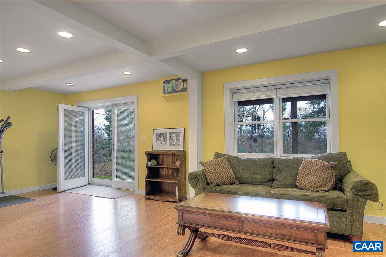 1532 Dairy Road Charlottesville, VA 22903 - Photo 30 of 42 An asymmetrical "coffered" style treatment to the ceiling carries that hint of modern design downstairs making it fresh & up-to-date. Large windows & glass doors bathe the space in soft daylight. A handy wetbar makes casual entertaining a snap.