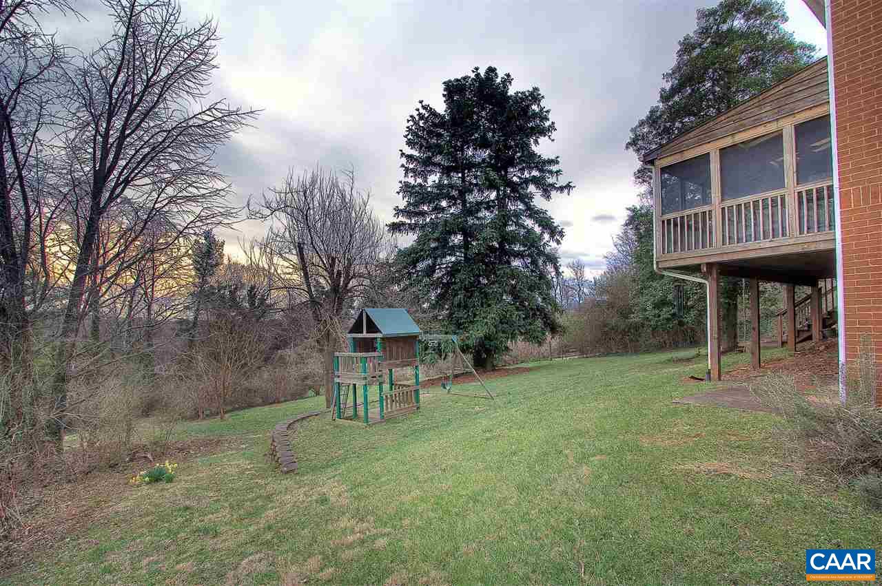 1532 Dairy Road Charlottesville, VA 22903 - Photo 36 of 42 The slope of the rear yard enable the home to command views & to "float" at branch height with the gorgeous mature trees around it. A small, curved retaining wall creates a level space for the super play gym which conveys.