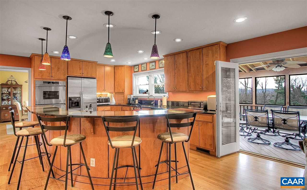 1532 Dairy Road Charlottesville, VA 22903 - Photo 7 of 42 Perfect for casual entertaining, the expansive curved eating bar, accommodates 6-8 guests. Custom handblown colored glass pendants add a warm glow & scintillating burst of color. Throw open the glass doors and overflow onto the screened porch.
