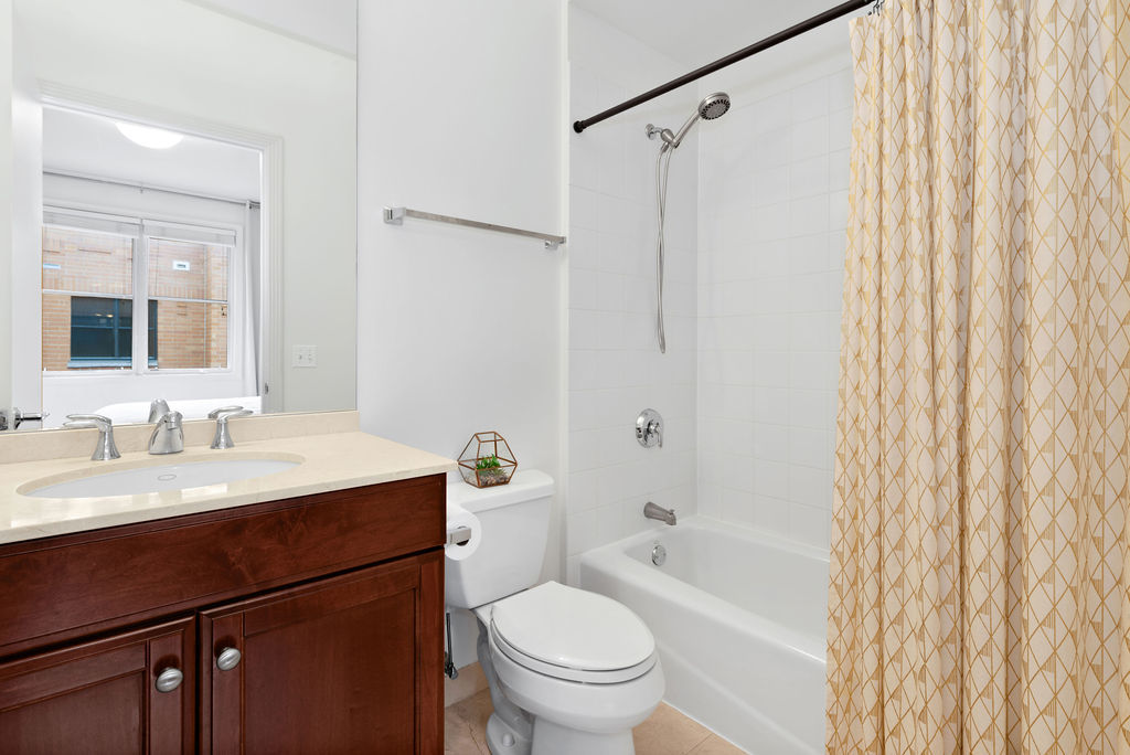 Undisclosed Address Chicago, IL 60607 - Photo 15 of 20 a bathroom with a granite countertop sink toilet and shower