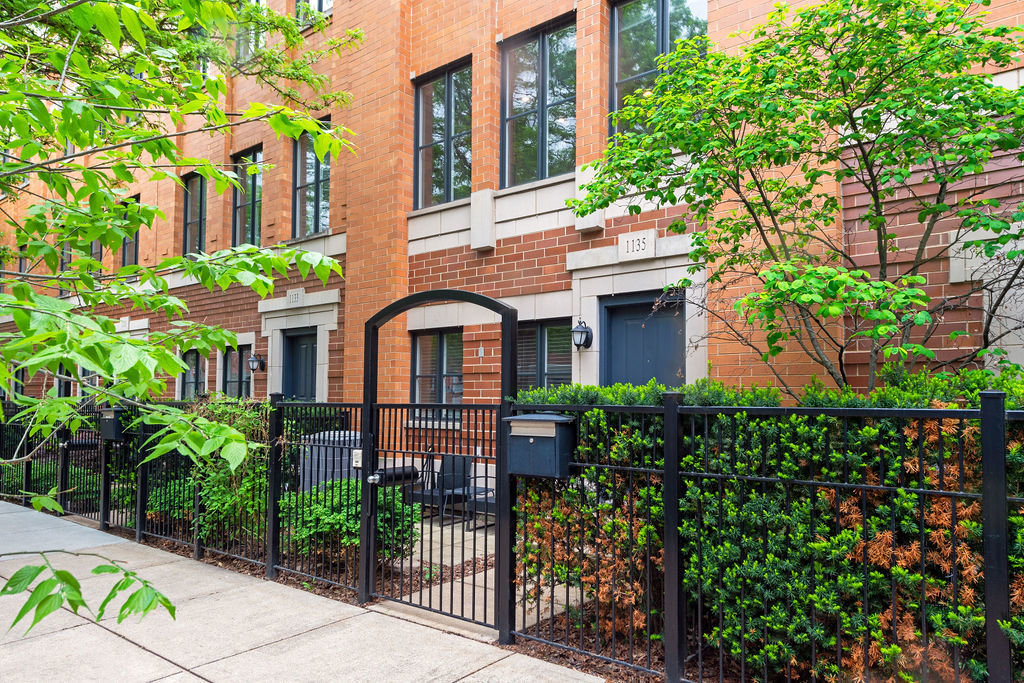 Undisclosed Address Chicago, IL 60607 - Photo 20 of 20 a front view of a house with a garden