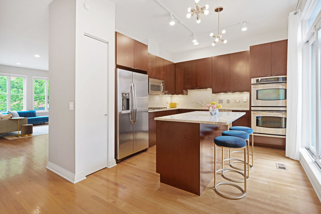 Undisclosed Address Chicago, IL 60607 - Photo 7 of 20 a kitchen with stainless steel appliances kitchen island granite countertop a refrigerator and a stove top oven