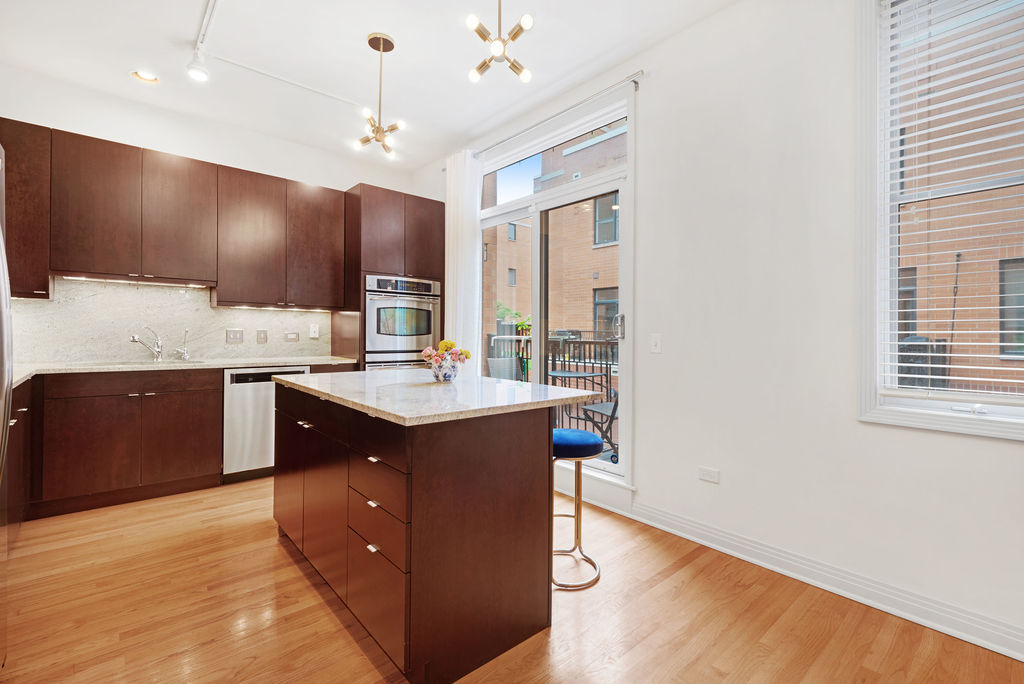 Undisclosed Address Chicago, IL 60607 - Photo 8 of 20 a kitchen with a sink cabinets and wooden floor