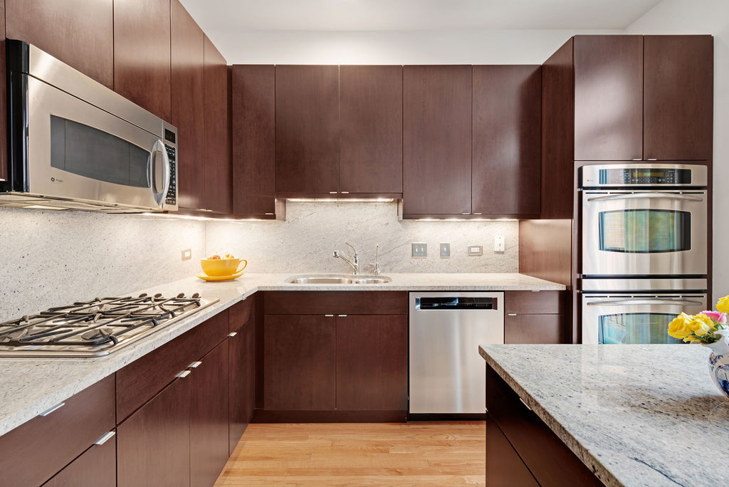 Undisclosed Address Chicago, IL 60607 - Photo 9 of 20 a kitchen with a sink appliances and wooden cabinets