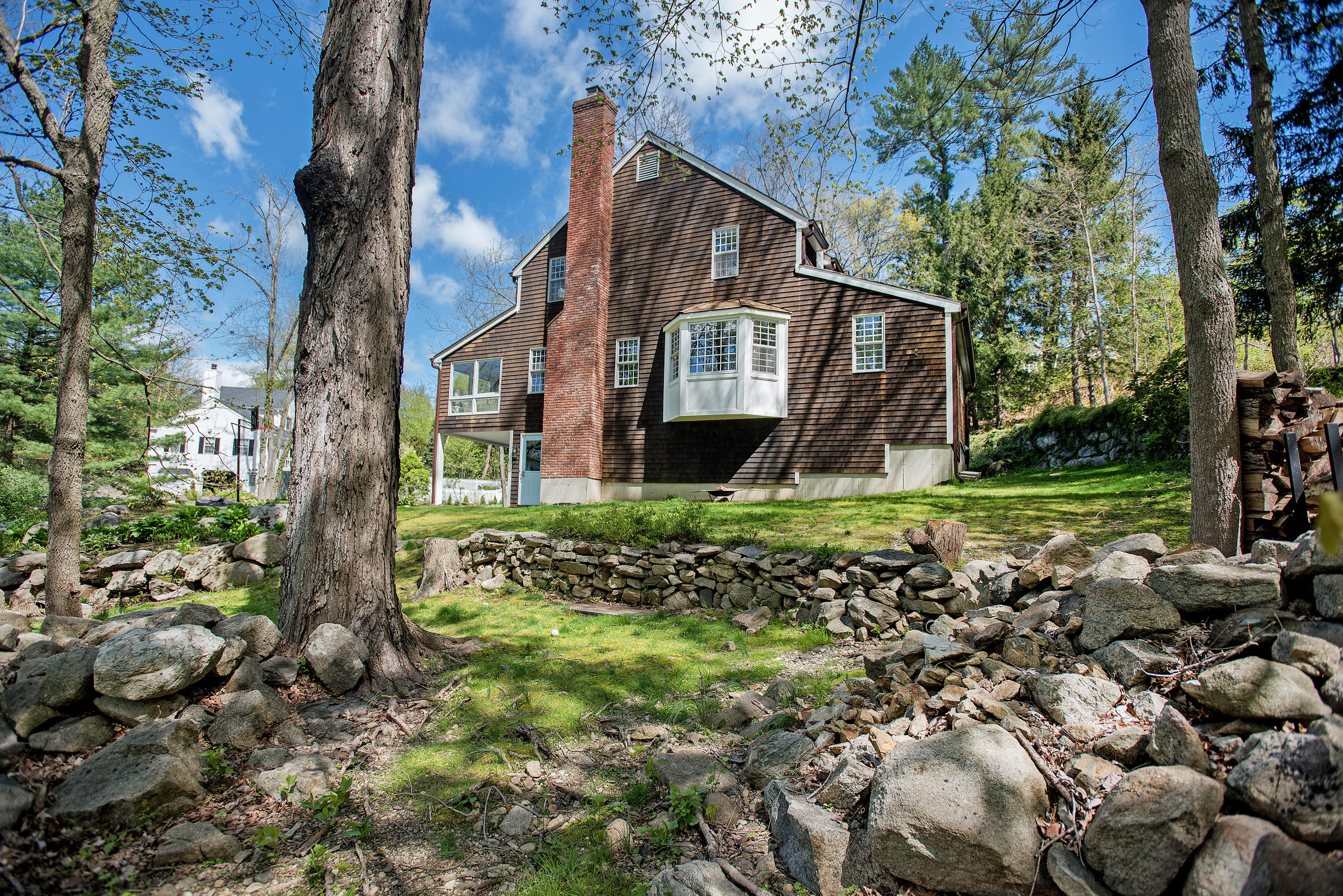 45 Brushy Ridge Road New Canaan, CT 06840 - Photo 22 of 23 a view of a house with a yard