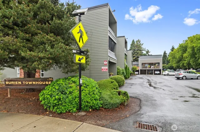 a front view of a house with garden and flowers