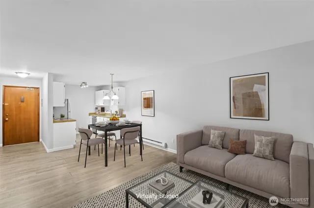 a living room with furniture a dining table and a piano table with wooden floor