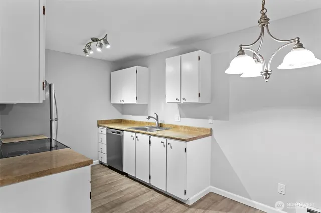 a kitchen with a sink cabinets and window