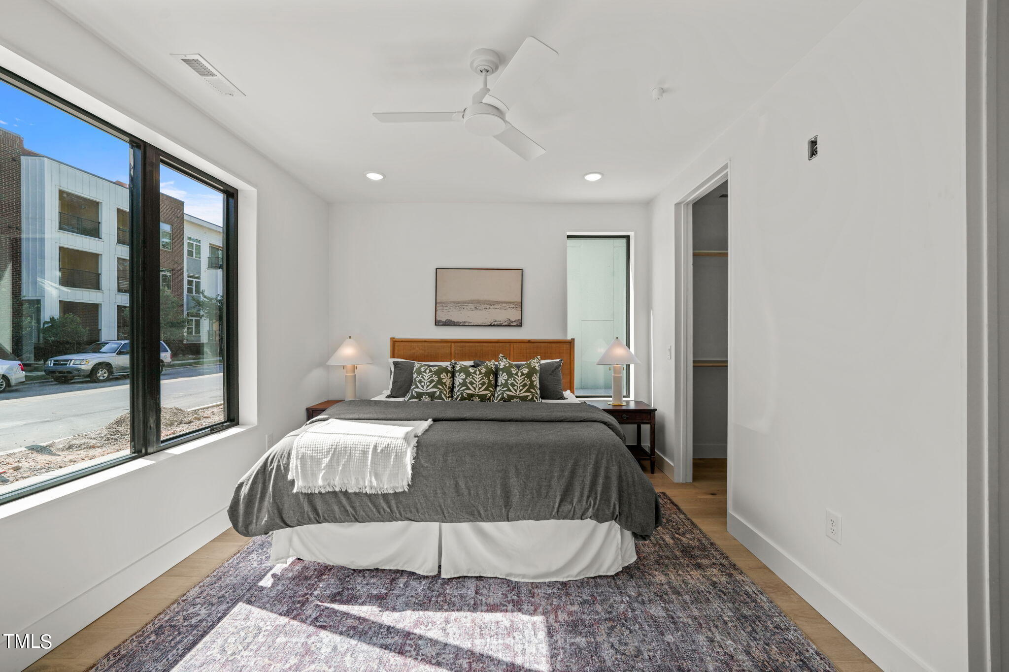 29 Enterprise Street, Unit 305 Raleigh, NC 27607 - Photo 14 of 48 a bedroom with a large bed and a chandelier