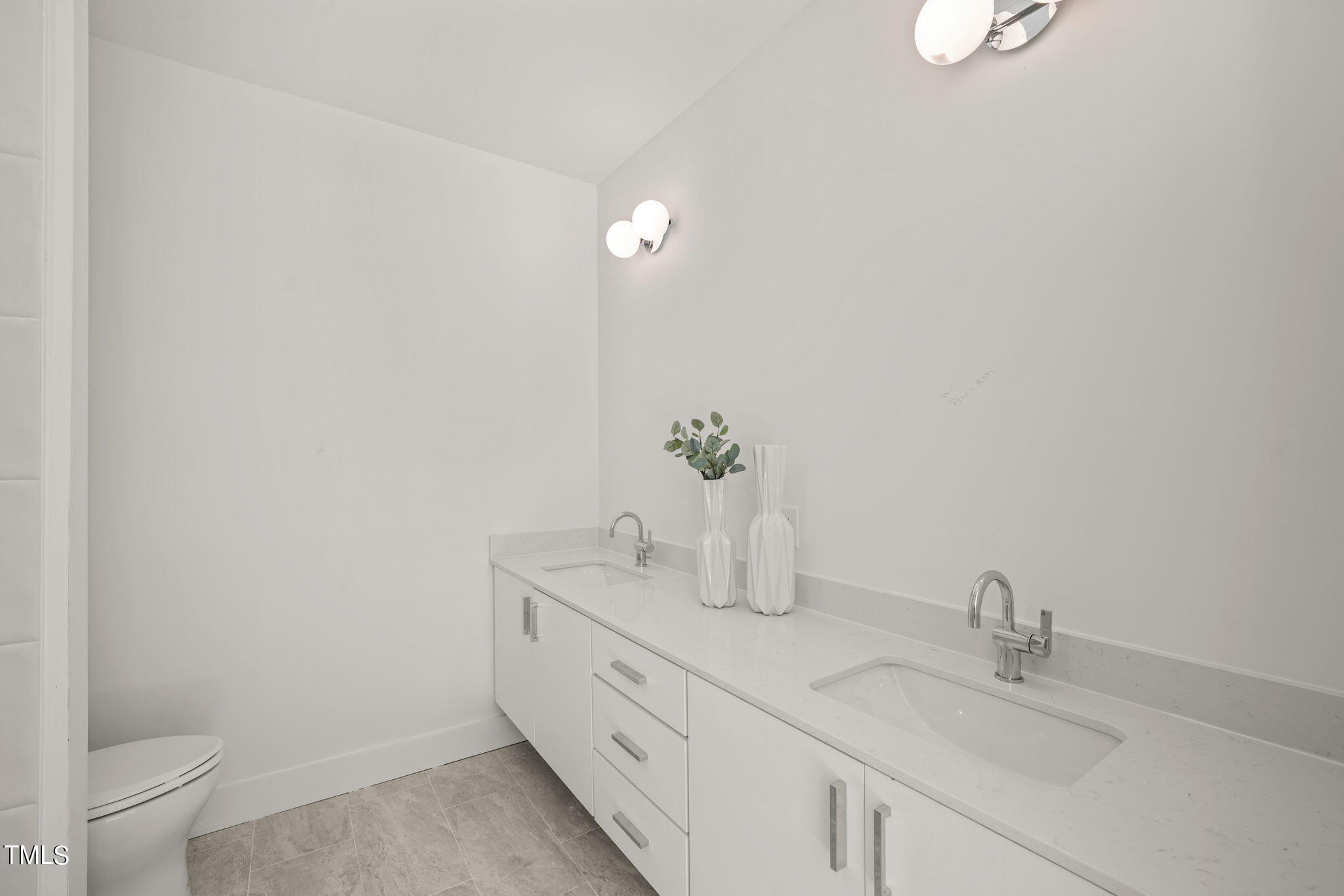 29 Enterprise Street, Unit 305 Raleigh, NC 27607 - Photo 18 of 48 a bathroom with a granite countertop sink a toilet and a mirror