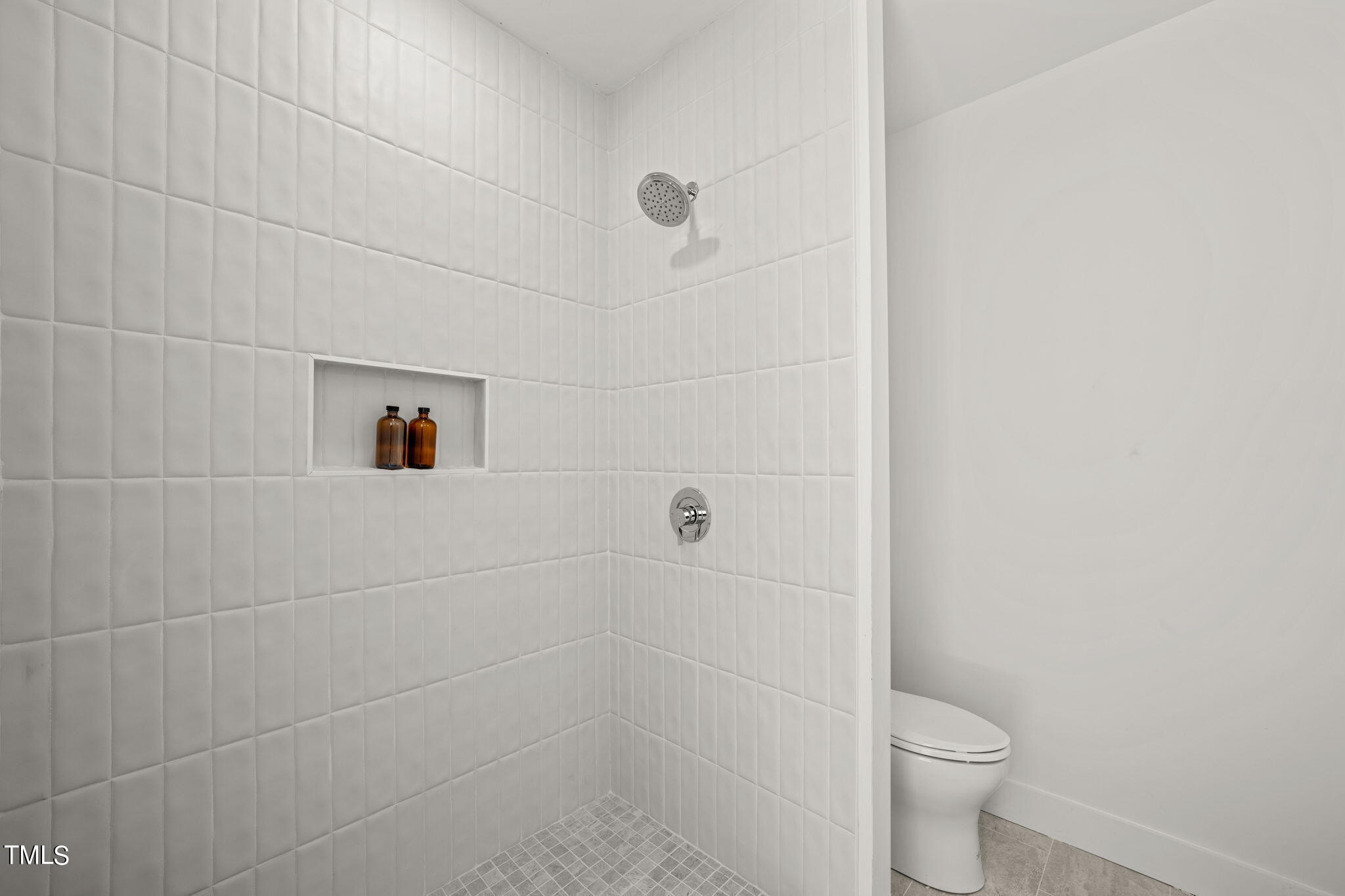 29 Enterprise Street, Unit 305 Raleigh, NC 27607 - Photo 19 of 48 a bathroom with a toilet and a shower