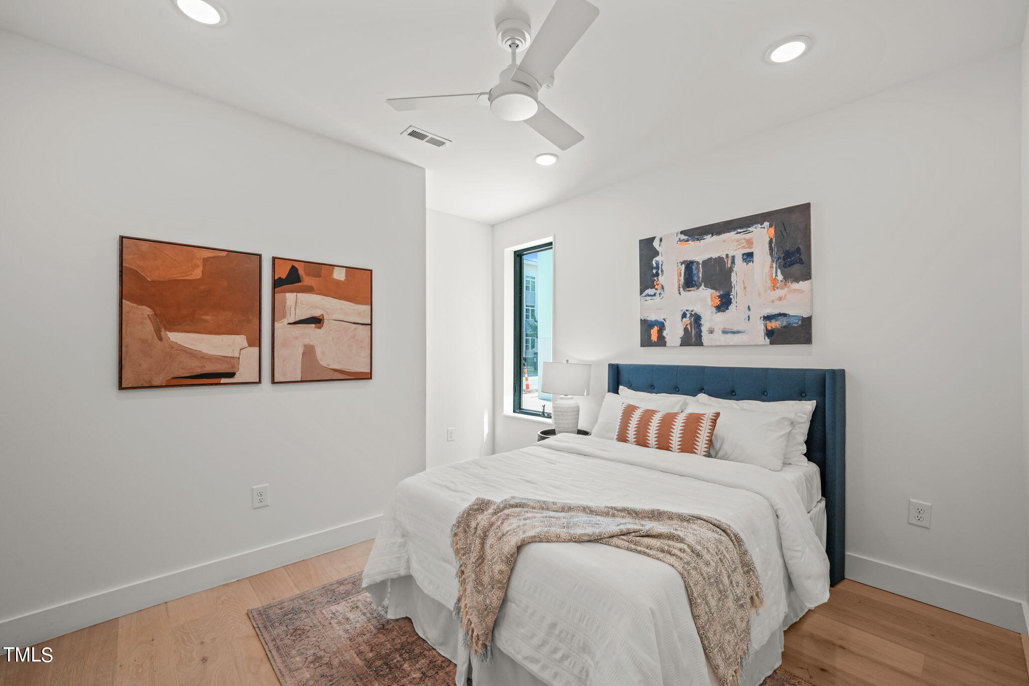 29 Enterprise Street, Unit 305 Raleigh, NC 27607 - Photo 20 of 48 a bedroom with a bed and wall painting