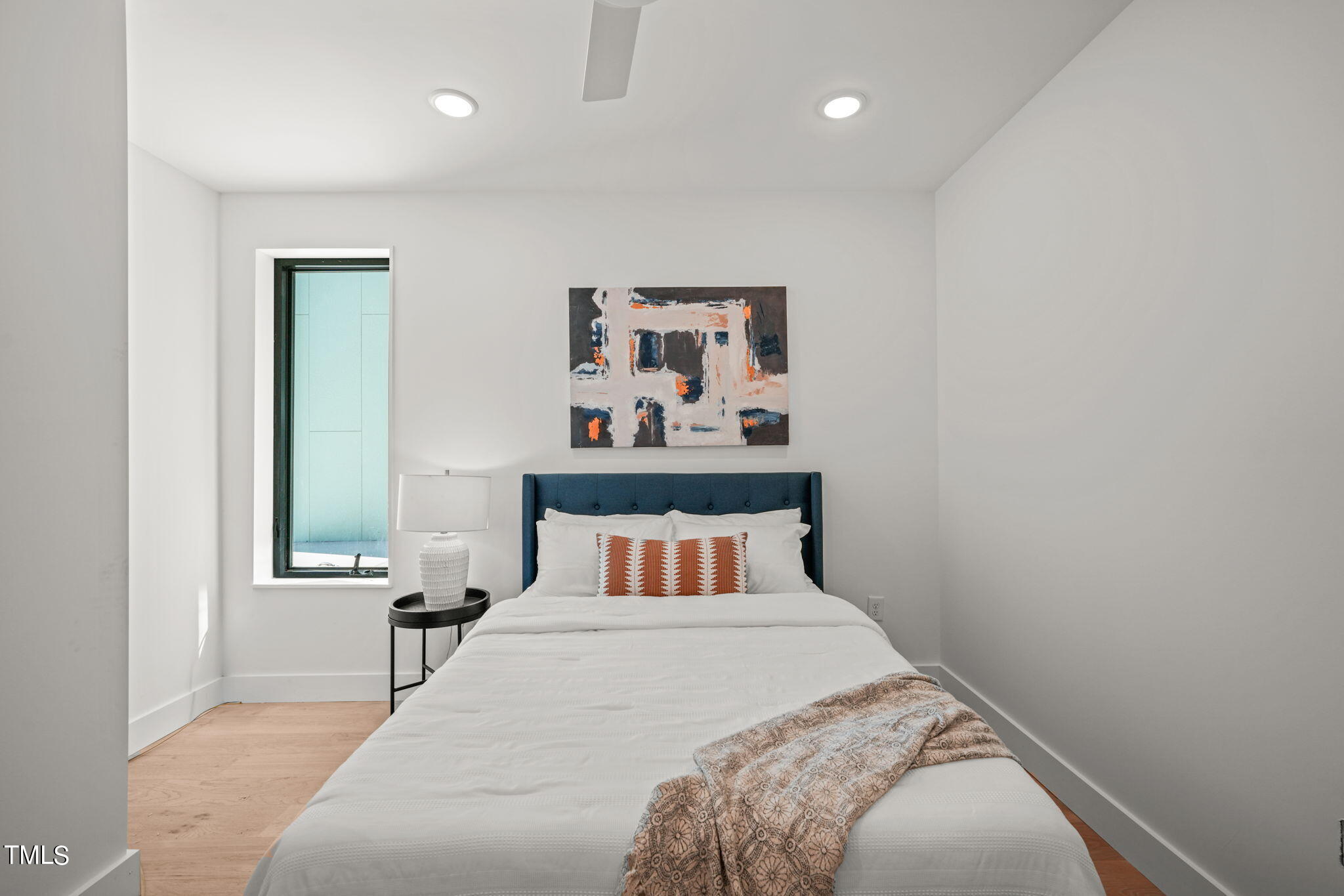 29 Enterprise Street, Unit 305 Raleigh, NC 27607 - Photo 21 of 48 a bedroom with a bed and window