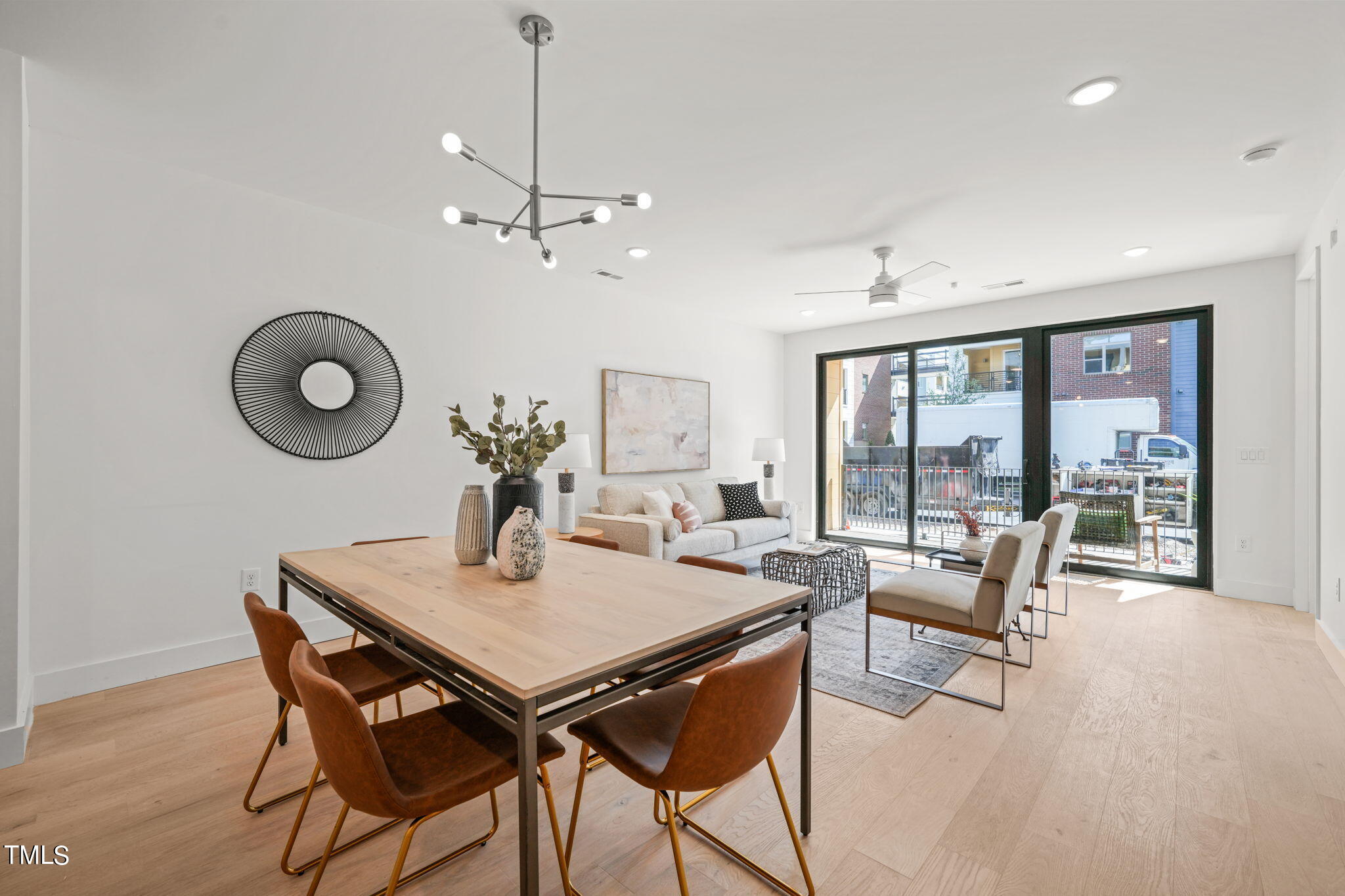29 Enterprise Street, Unit 305 Raleigh, NC 27607 - Photo 5 of 48 a view of a dining room with furniture wooden floor and chandelier