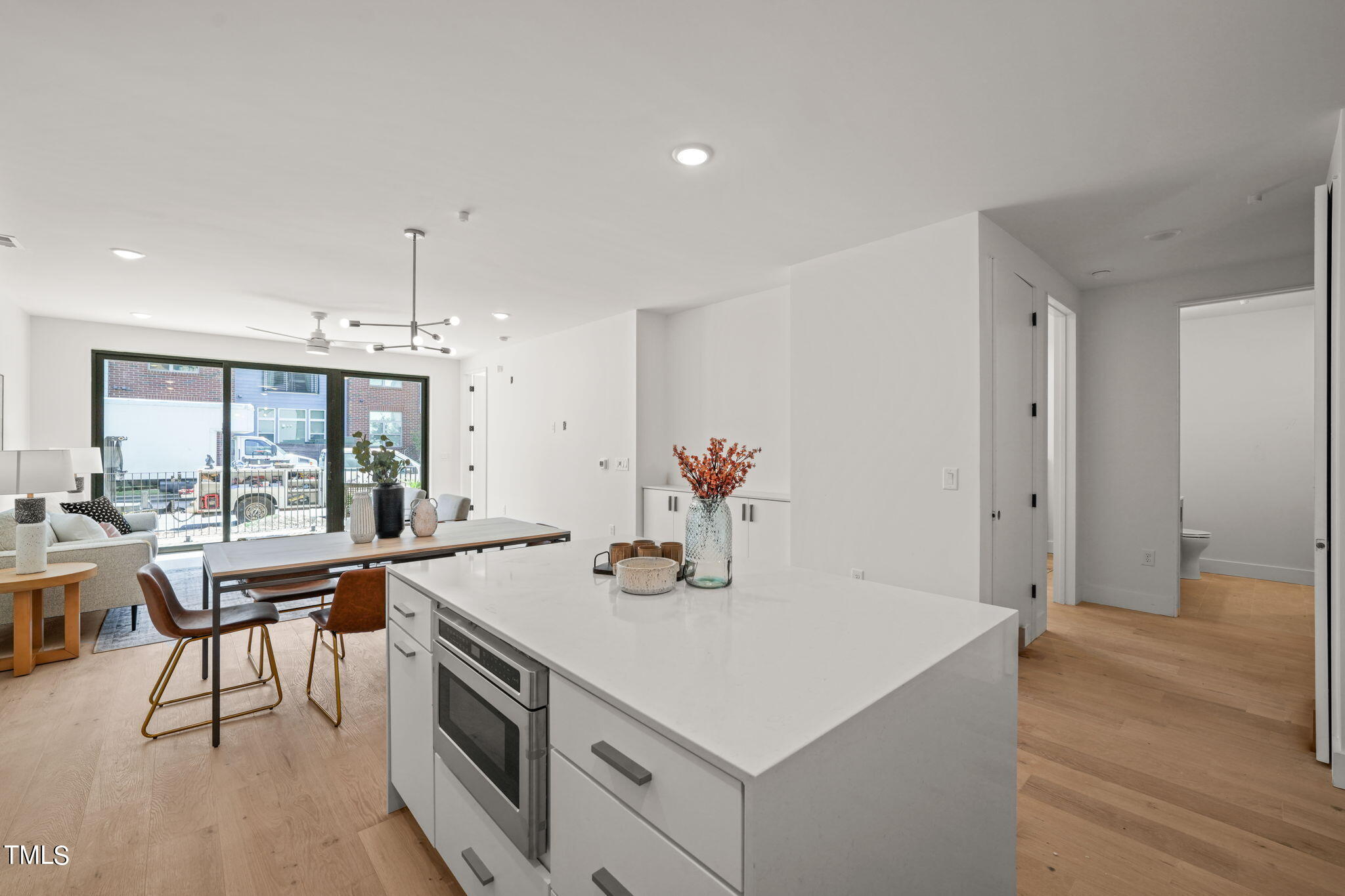 29 Enterprise Street, Unit 305 Raleigh, NC 27607 - Photo 7 of 48 a kitchen with a table chairs and white cabinets