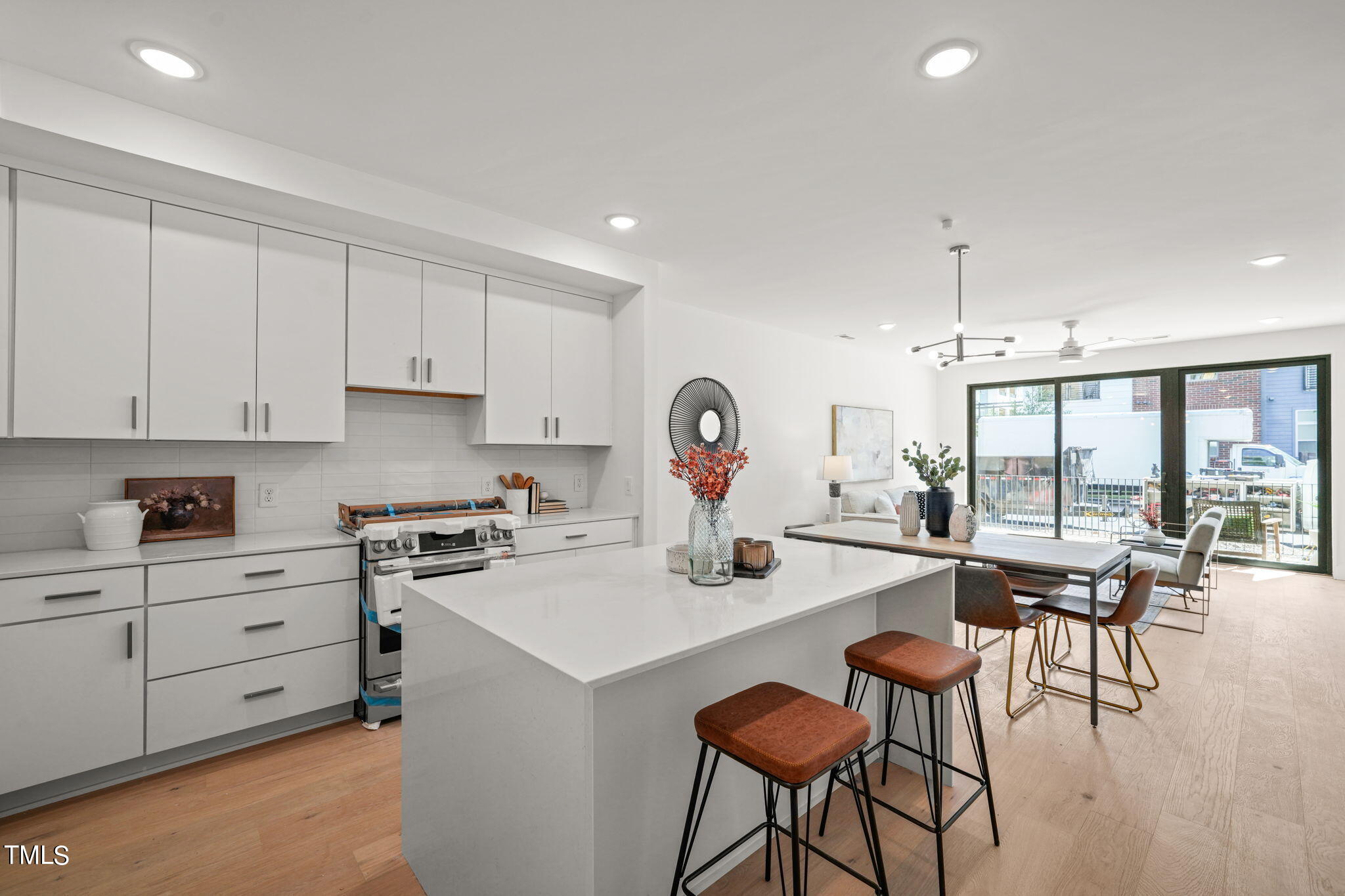 29 Enterprise Street, Unit 305 Raleigh, NC 27607 - Photo 8 of 48 a kitchen with a table chairs stove and cabinets