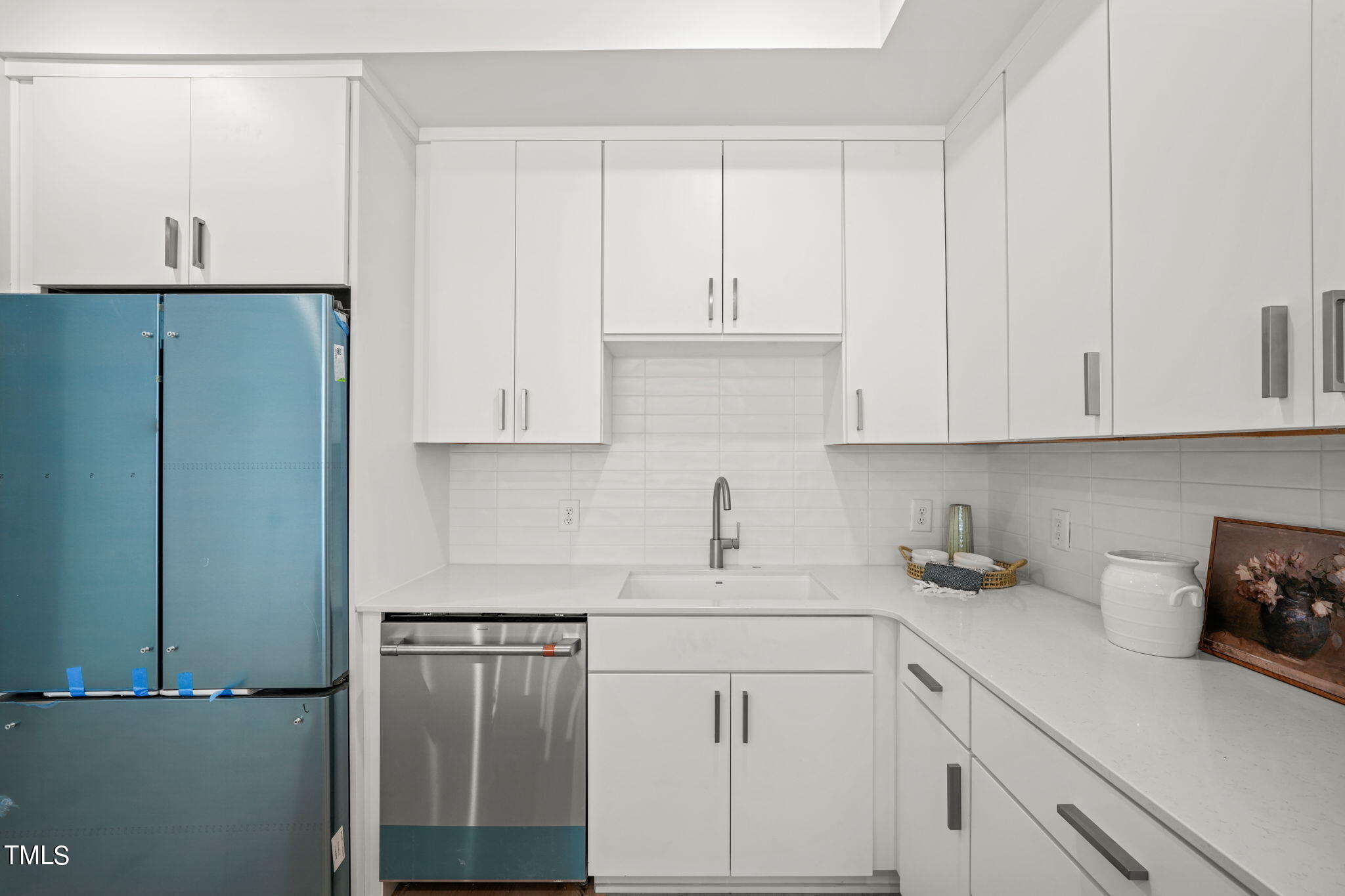 29 Enterprise Street, Unit 305 Raleigh, NC 27607 - Photo 9 of 48 a kitchen with a sink and cabinets
