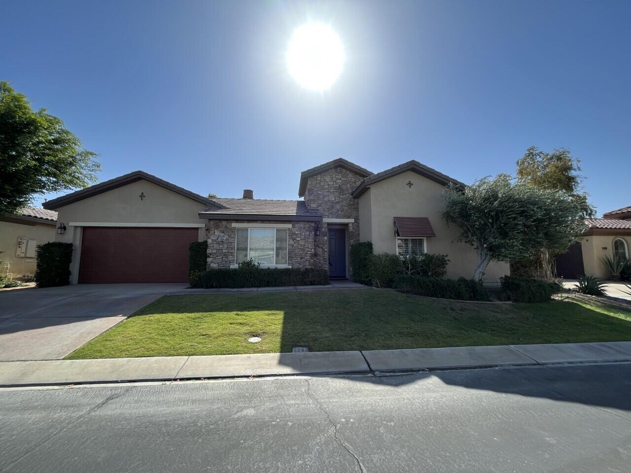 40844 Piazza Del Paradiso Indio, CA 92203 - Photo 1 of 22 a front view of a house with a yard and garage
