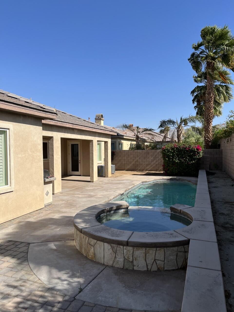 40844 Piazza Del Paradiso Indio, CA 92203 - Photo 18 of 22 a view of a house with backyard tub and garden