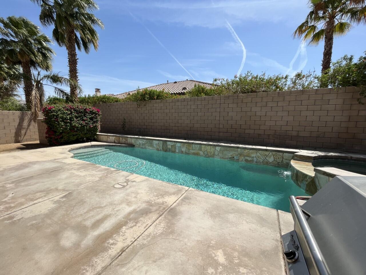 40844 Piazza Del Paradiso Indio, CA 92203 - Photo 21 of 22 a view of a lake with a house in the background