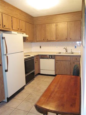73 Walnut Street, Unit 6 Newton, MA 02460 - Photo 2 of 8 a kitchen with cabinets and white appliances