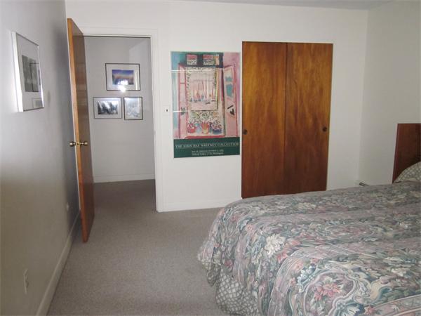 73 Walnut Street, Unit 6 Newton, MA 02460 - Photo 5 of 8 a bedroom with a bed and wall painting