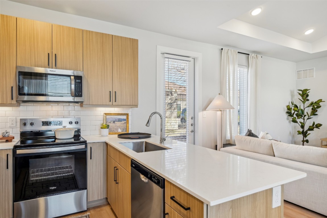 3651-210 South Custer Road McKinney, TX 75070 - Photo 15 of 28 a kitchen with a sink a stove and cabinets